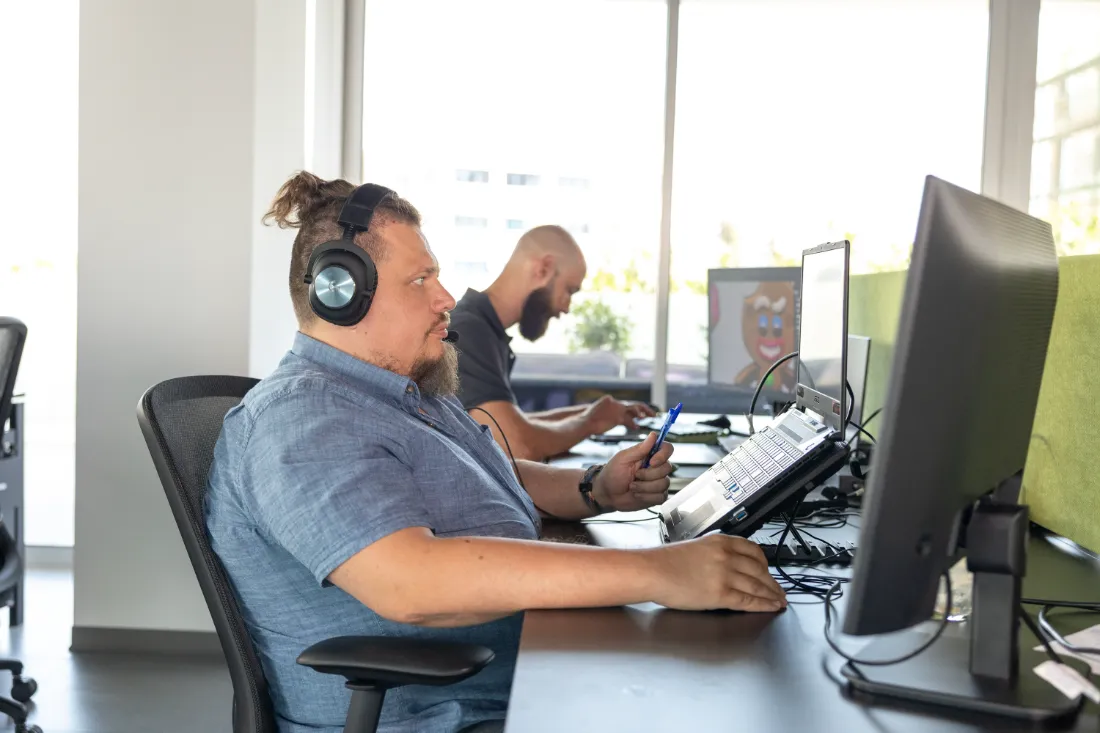 Two developers working beside concept art